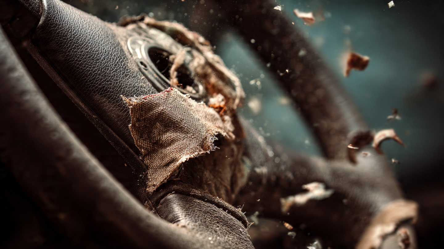 Shattered airbag module with exposed metal inflator housing