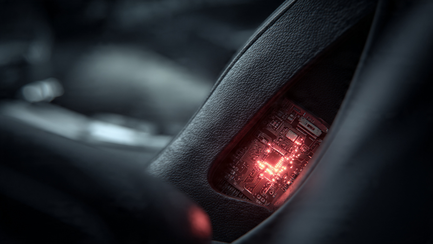 Close-up of airbag module inside car door panel with glowing red circuit board